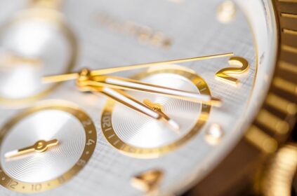 wrist clock close up golden clock face with ticking arms
