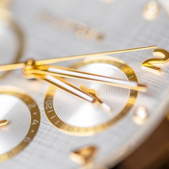 wrist clock close up golden clock face with ticking arms